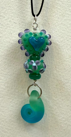 Sea foam green heart with spiral bead and silver, 2 3/4” long